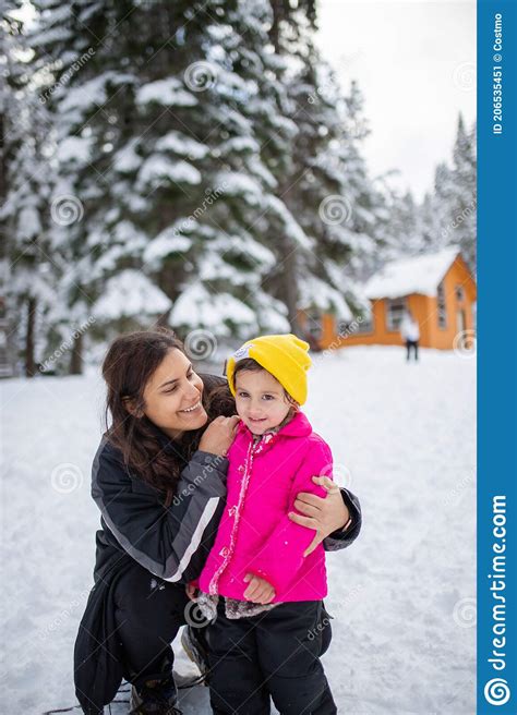 Happy Mother And Daughter Smiling In A Snowy Forest Stock Image Image