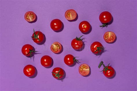 Bright Cherry Tomatoes In Hard Light With Shadow On Violet Background