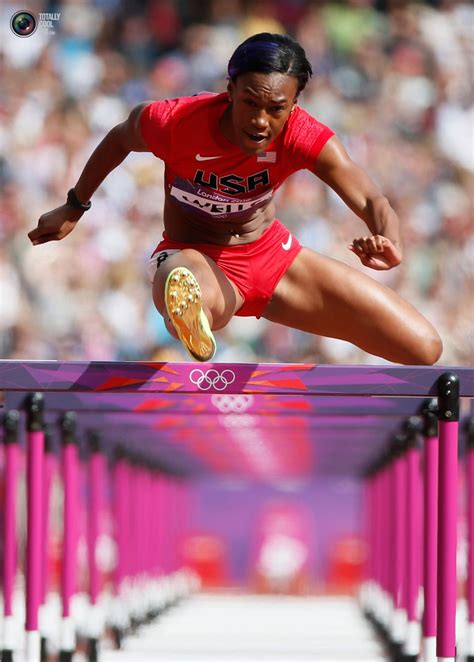 Kellie Wells Of The Us Clears A Hurdle During Her Womens 100m