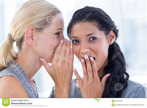 Businesswoman Whispering Gossip To Her Colleague Stock Image - Image of ...