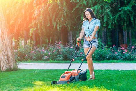 Woman Mowing Lawn In Residential Back Garden On Sunny Day — Stock Photo