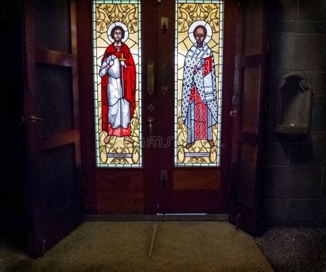 Wooden Church Doors With Stained Glass Saints Leading To The Outside