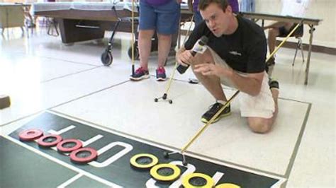 Athletes Prepare To Compete In Shuffleboard As Part Of Senior Olympics