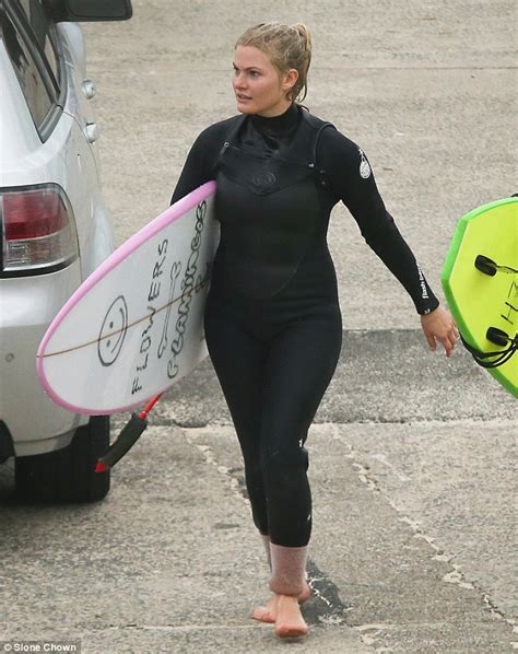 Home And Aways Bonnie Sveens Curvy Wetsuit Clad Figure In Surf