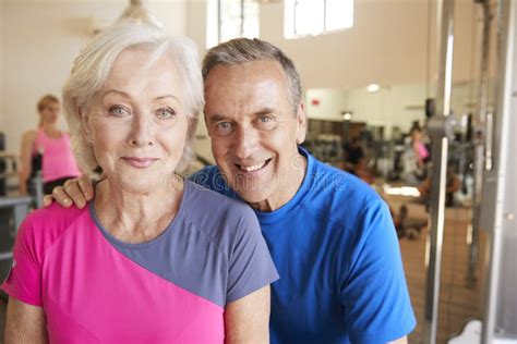 Portrait Of Active Senior Couple Exercising In Gym Together Stock Image