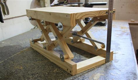 Homemade motorcycle lift constructed from 3/4 plywood, gi pipe, and wooden planks. How to make your own DIY scissor lift with plans ...
