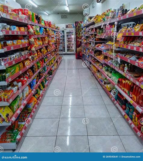 Aisle With Various Kinds Of Snacks And Drinks On The Shelves Inside