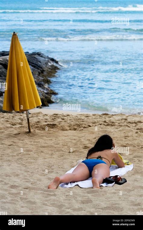 Rear View Of A Woman Lying On The Beach Waikiki Beach Honolulu Oahu Hawaii Islands USA