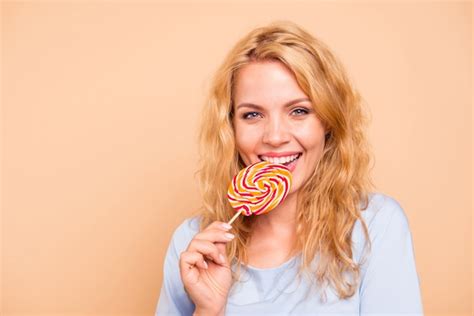 Premium Photo Beautiful Woman Posing While Holding Candy