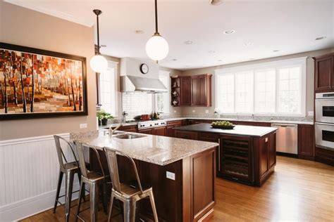 Transitional Eat In Kitchen Features Metal Barstools And Dark Wood