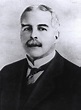 an old black and white photo of a man in a suit with a moustache
