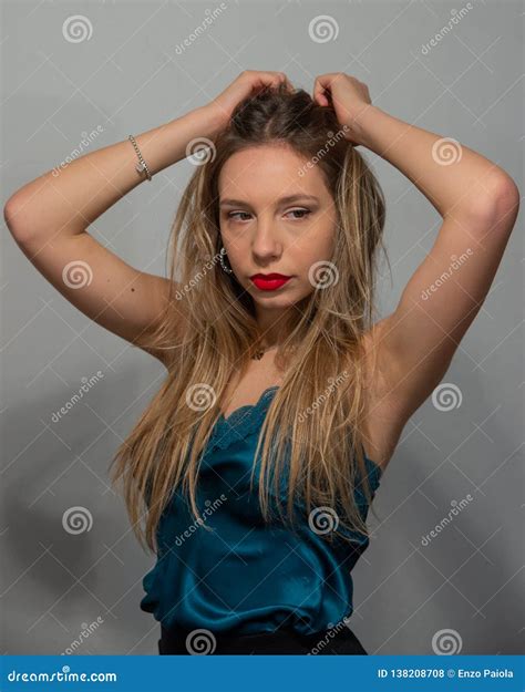 Half Length Portrait Of Blonde Girl In Blue Satin Tank Top With Lace