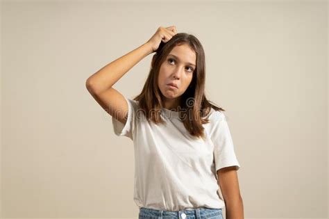 Portrait Of Brunette Girl Or Young Woman With Puzzled Bewildered Dumb