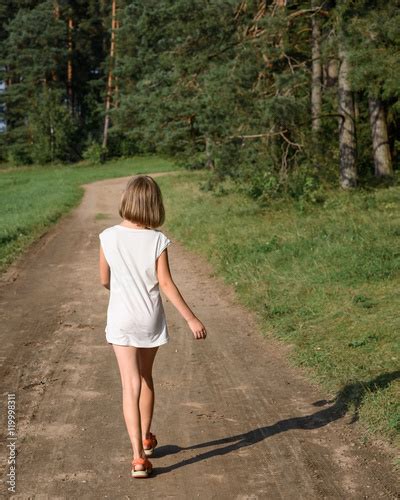 Little Girl Walking Along Summer Road Into Woods Stock Photo Adobe Stock