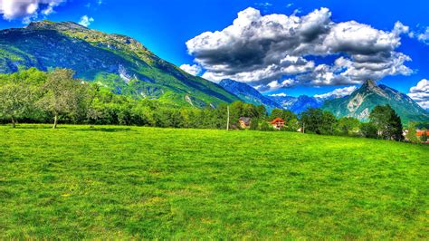Slovenia Green Field Of Grass Mountains Alpes Blue Sky Clouds White