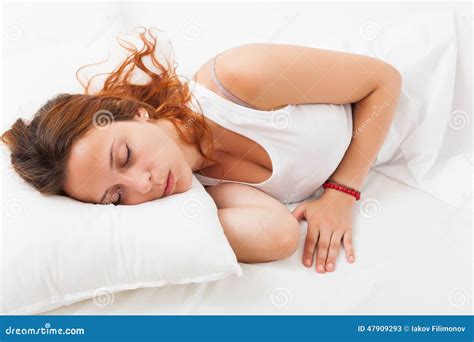 Red Haired Girl Quietly Sleeping On A White Pillow In Bed At Ho Stock