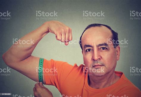 Man Flexing His Muscle Measuring His Biceps Stock Photo Download