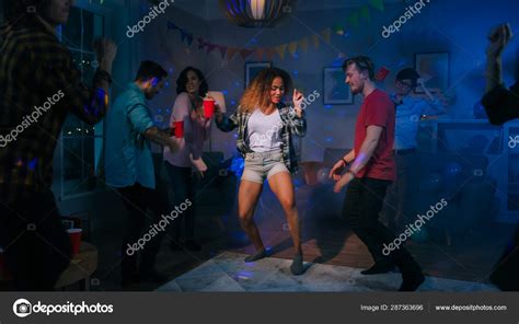 At The College House Party Sexy Couple Dances With Diverse Group Of Friends Having Fun Around