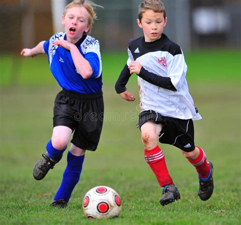 Youth Soccer Players Running After The Ball Editorial