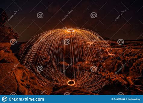 Burning Steel Wool On The Rock Near The River At Sam Phan Bok In