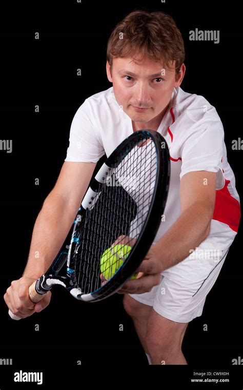 Portrait Of A Young Male Tennis Player About To Serve The Ball Over