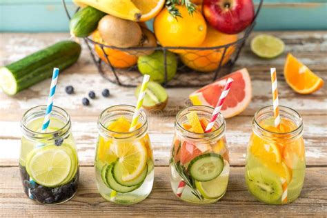 Fruit Infused Detox Water In Glass Jars And Ingredients Stock Photo