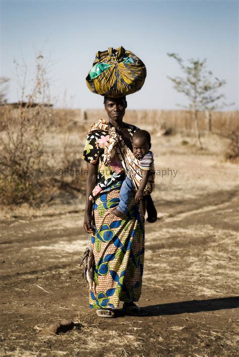 African woman carrying baby with washing in village setting | Advertising Photographer San Diego ...