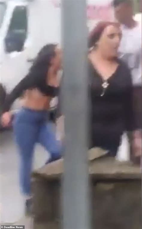 woman s top is almost ripped off in vicious brawl with another woman on the side of a busy road