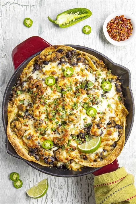 Spoon half of the chicken mixture over the tortillas, and sprinkle with half of the cheese and half of the sour cream. Chicken Enchilada Casserole Verde Recipe - Chili Pepper ...