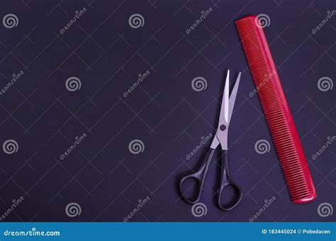 Hairdressing Scissors With A Red Comb On A Black Background With Copy