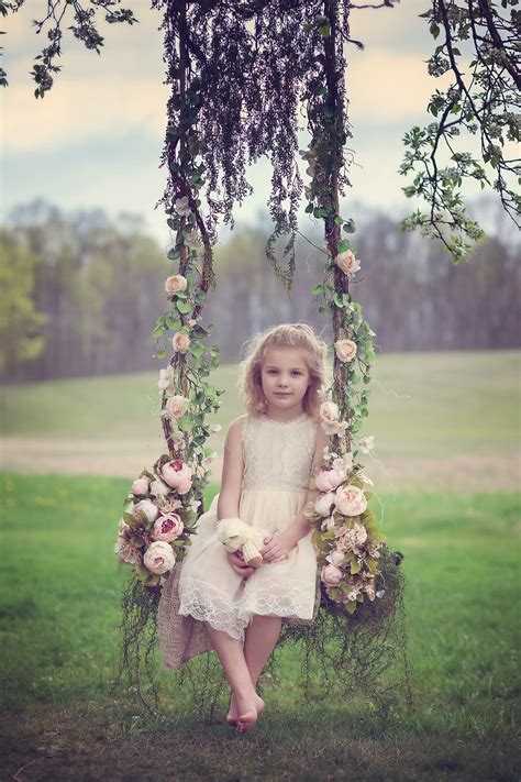 Wooden Swing Flowers And A Beautiful Little Girl Children