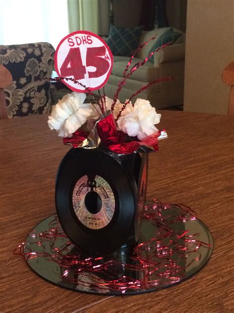 There Is A Vase With Flowers In It On Top Of A Table That Has A 45 Sign