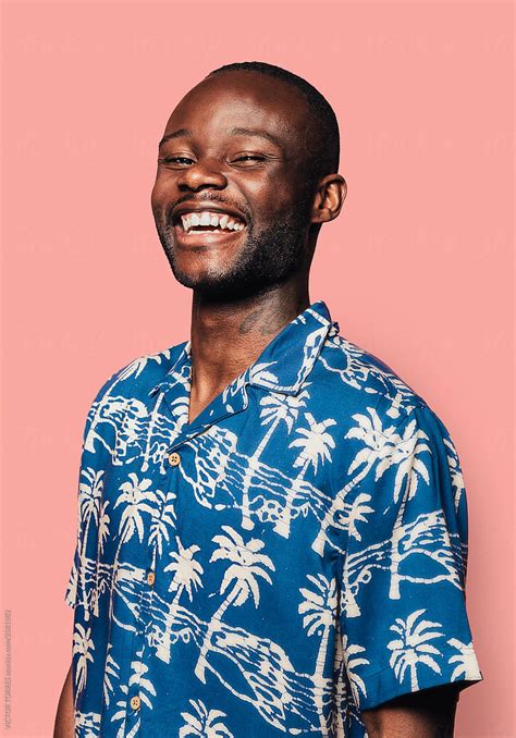 Portrait Of Handsome Black Man Looking At Camera And Laughing By