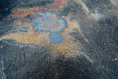 Dirty Multi Colored Stain From Engine Oil On Asphalt Stock Image