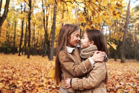 Cute Two Little Sisters Hugging In Autumn Park Outdoor Stock Image Image Of Friends Girl