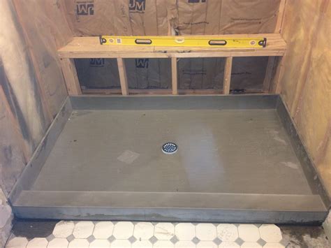 Solid Shower Pan Being Installed For New All Marble Tile Shower