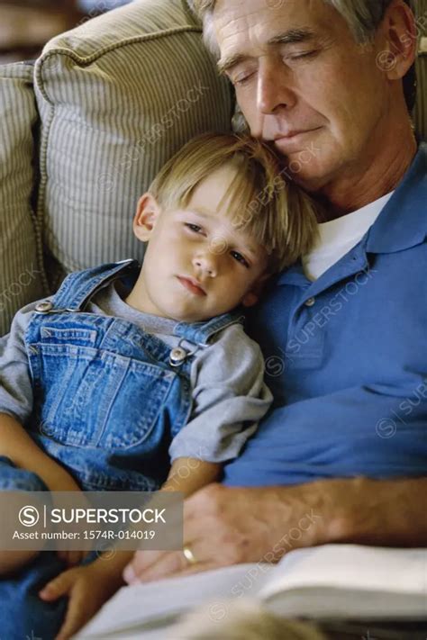High Angle View Of A Grandfather Sleeping With His Grandson Superstock