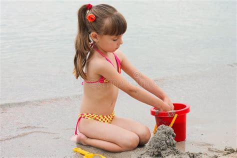 Girl Playing With Sand On The Sea Shore Stock Photo Image Of Beach Sand