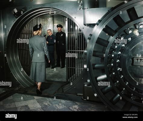 1940s 1950s Woman Walking Into Private Bank Vault Bank Teller And Guard