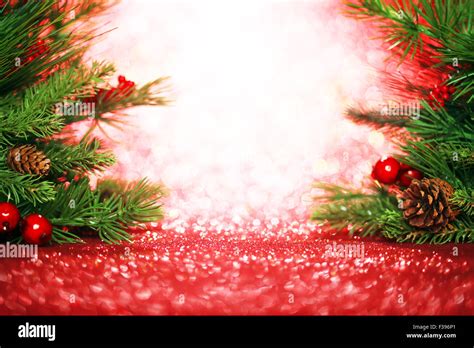 Christmas Tree Branches On Glittering Red Background Stock Photo Alamy