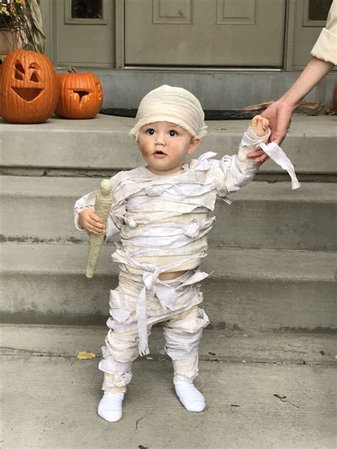A Little Boy Dressed Up As A Baby In A Costume