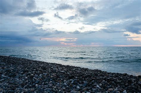 Rocky Shore Under Cloudy Skies · Free Stock Photo
