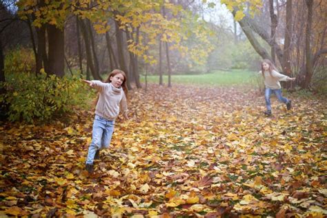 Children In The Autumn Park Run Jump And Play Stock Photo Image Of