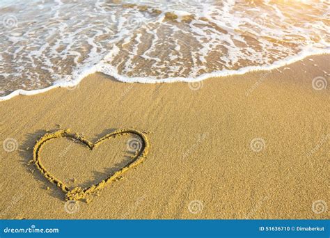 Hand Drawn Heart On Beach Sand Over Soft Gold Sunset Love Stock Photo