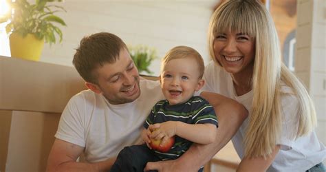 Portrait Of Husband And Wife And Playing With Their Little Son In New