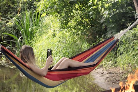 Girl In A Hammock With A Phone In His Hand Stock Image Image Of