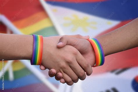 Closeup View Of Handshaking Of Lgbt People With Blurred Rainbow Background Concept For Success