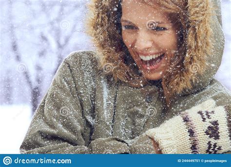 loving the first snowfall shot of an attractive woman enjoying herself outside in the snow