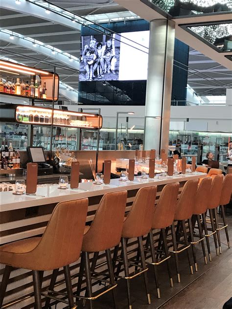 Lunch with a view on the tarmac, a bar and an open kitchen in a classy setup decorated with grab a seat and browse the menu: Gordon Ramsay's new Plane Food Heathrow Terminal 5 review ...