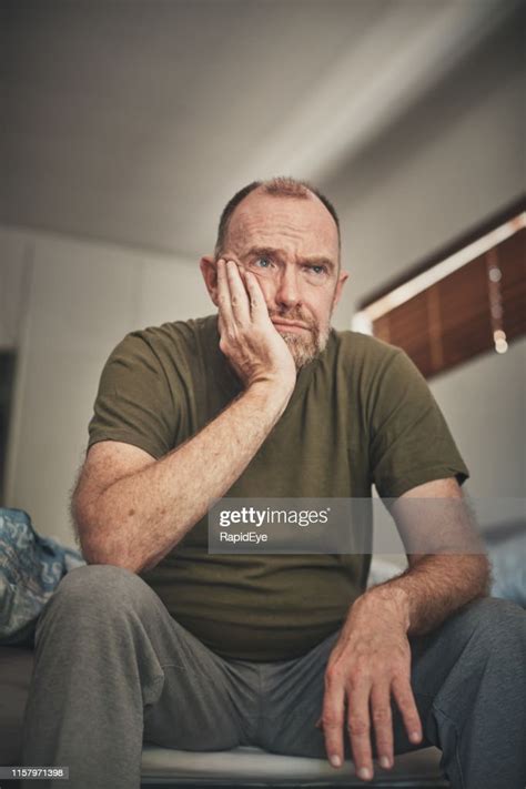 Tired And Despairing Mature Man In His Bedroom In The Morning High Res